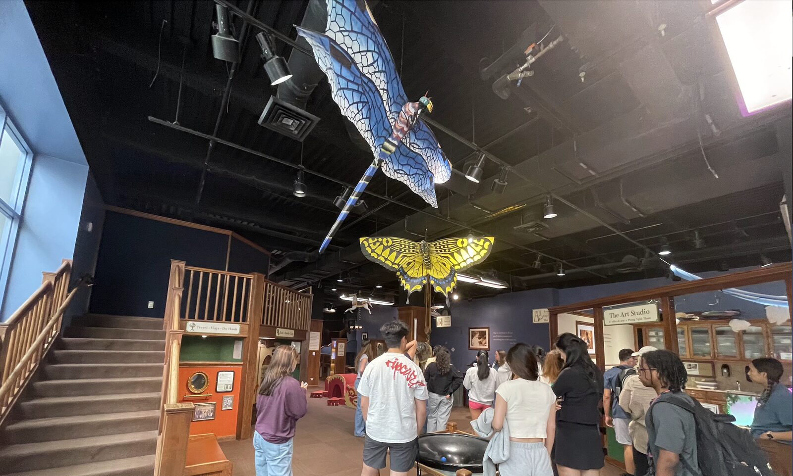 Butterfly sculptures suspended above an exhibit floor at CDM