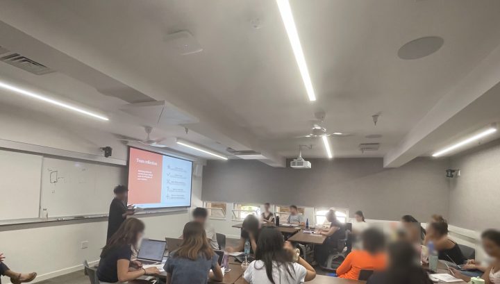 Students working in teams in a Stanford classroom during a team reflection session